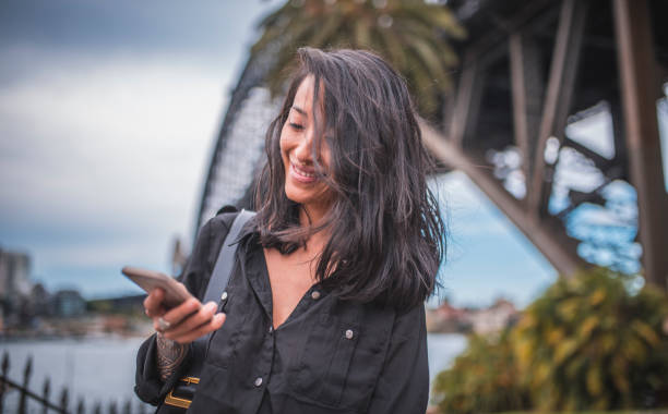 istock Asian woman using phone in Sydney 924955352