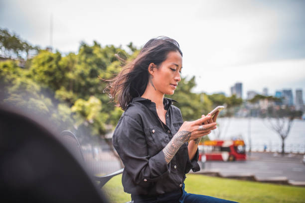 istock Asian woman using phone in Sydney 924955376