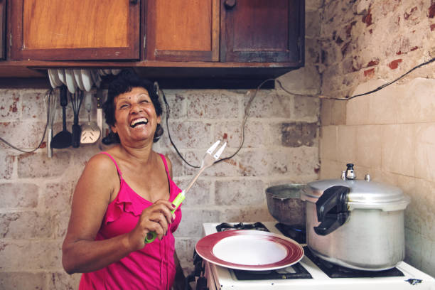 Cuban grandmother cooking Cuban grandmother cooking cuban ethnicity stock pictures, royalty-free photos & images