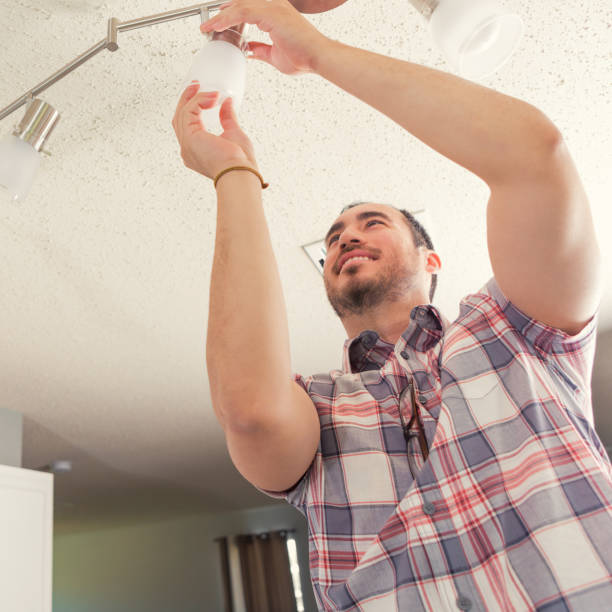 istock New homeowner changes lightbulb in his home 924958262