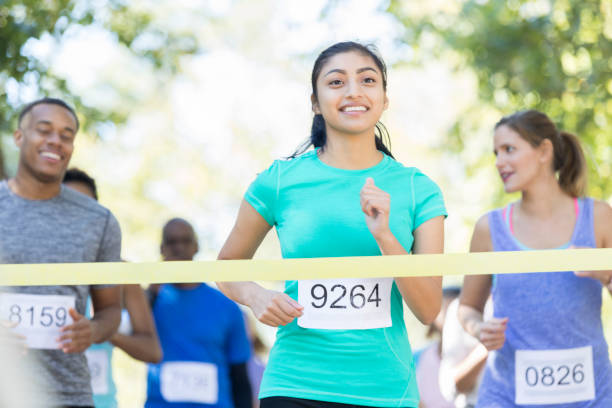 istock Female runner crosses finish line 924958724