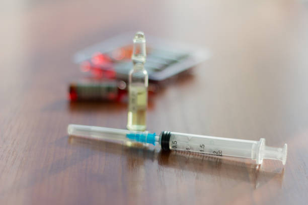 istock medicines, injectable ampoules and syringe on the table 924958920