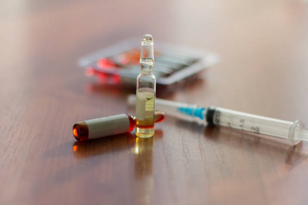 istock medicines, injectable ampoules and syringe on the table 924959052