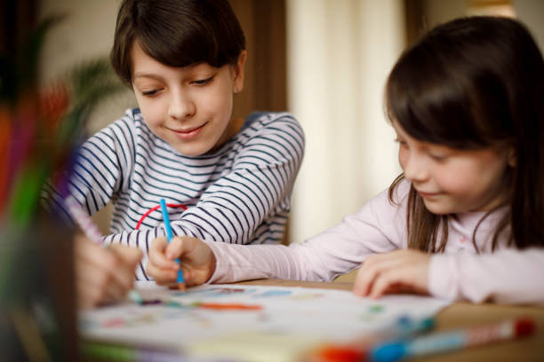 istock Sisters drawing together at home 924961832