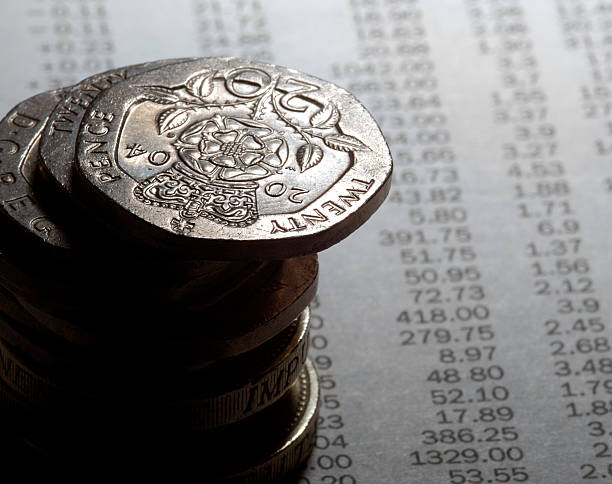 istock coins on newspaper stock prices 92496779