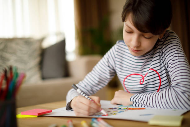 istock Cute young teenage girl doing homework project 924968332