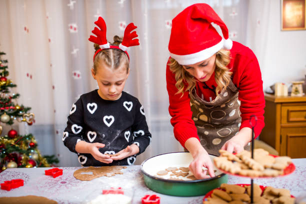 istock Happy young girl with her mother making dough 924968384