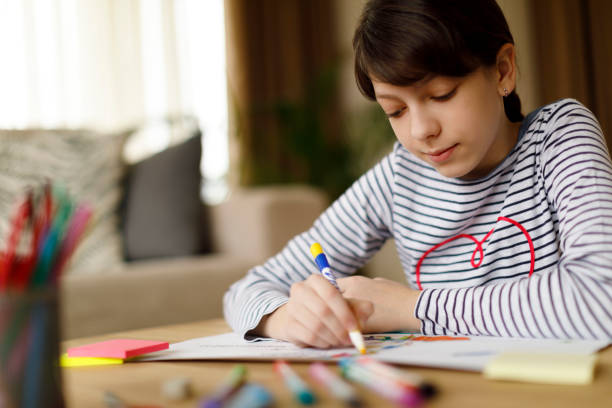 istock Cute teenage girl doing homework project 924968456
