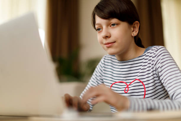istock Cute teenage girl using laptop to studying 924968892