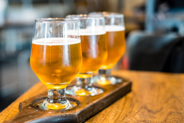 istock 3 cups of draft been on wooden table 924969408