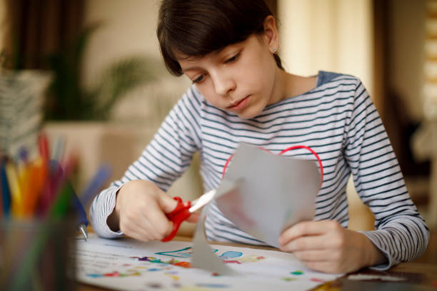 Cute young teenage girl doing homework project