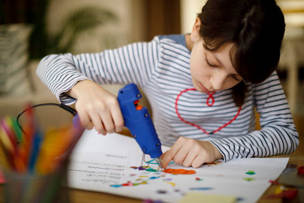 istock Cute young teenage girl doing homework project 924969736
