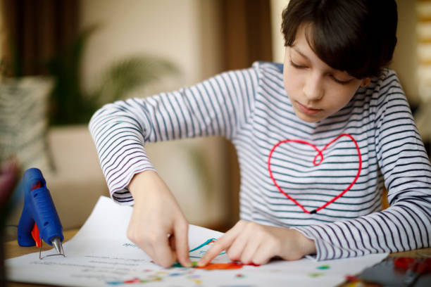 istock Cute young teenage girl doing homework project 924971208