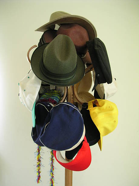 Hat stand holding a variety of different hats stock photo