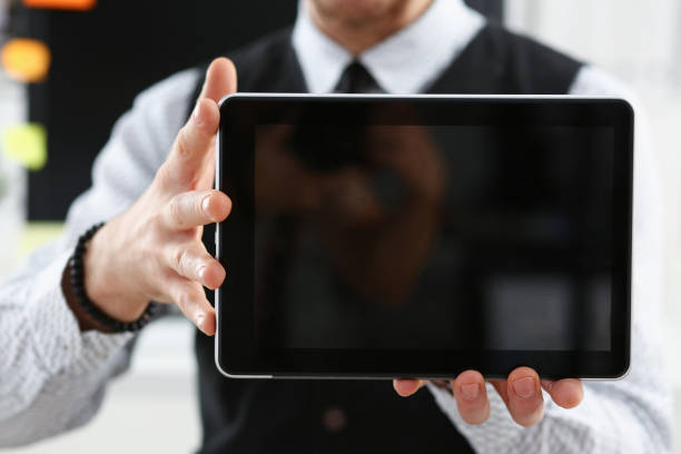 istock Male arm show tablet pc screen to camera closeup 924972494