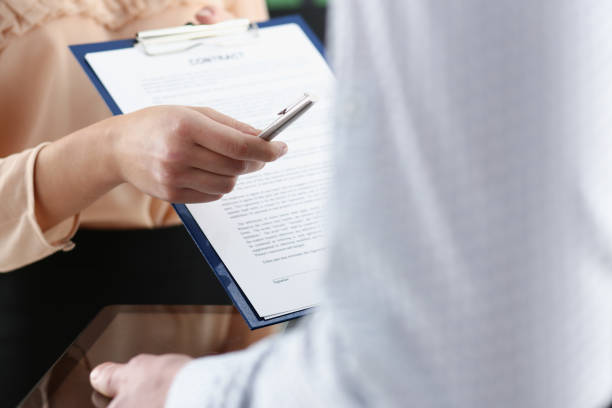 istock Smiling woman offer contract form 924972574