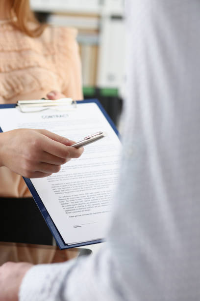 istock Smiling woman offer contract form 924972584