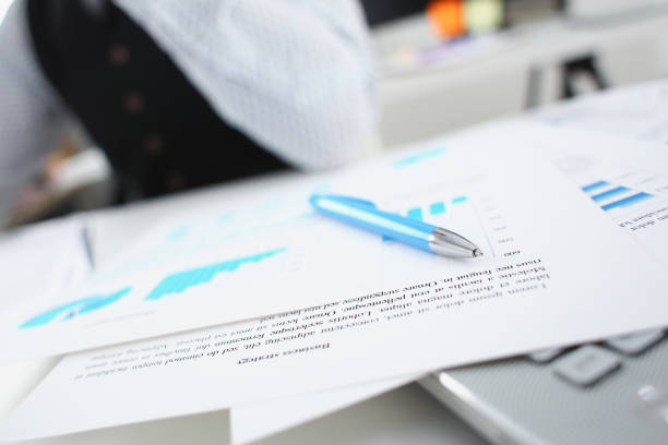 istock Silver pen lying on important paper at table 924972626