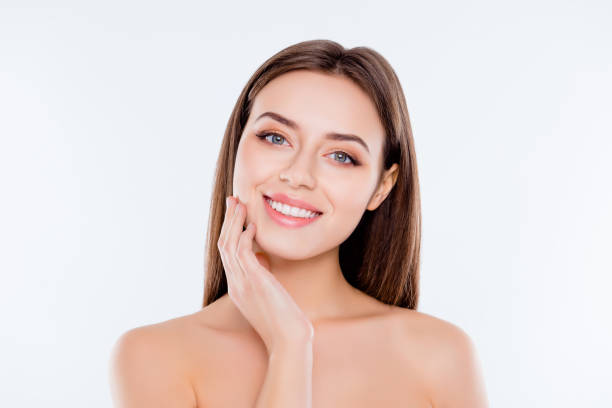 clean clear pampering wellness freshness rejuvenation concept. close up portrait of beautiful tender cute pure girl touching her smooth soft flawless perfect skin on cheek isolated on white background - face mask imagens e fotografias de stock