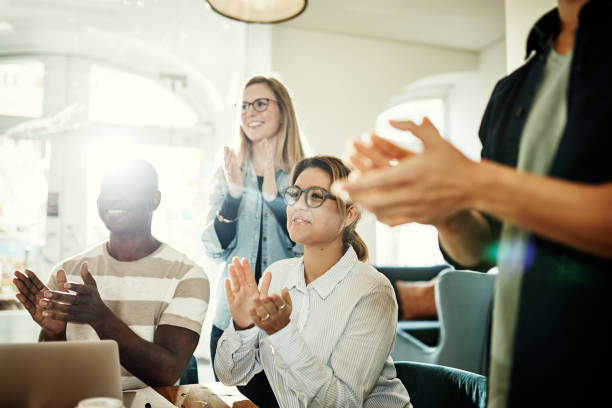 istock Diverse group of smiling colleagues clapping during an office presentation 924977578