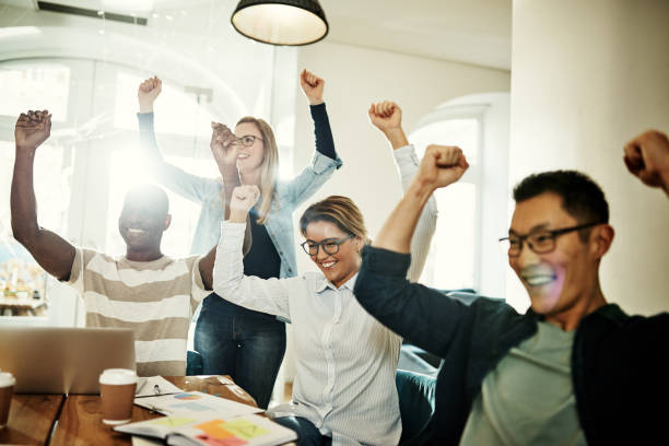 istock Ecstatic group of diverse coworkers cheering together in an office 924977710