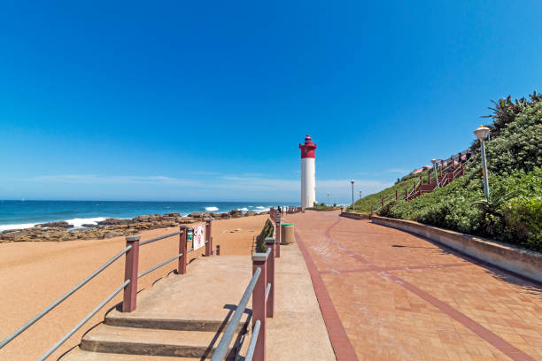 istock Landscape of  Lighthouse on Paved Beachfront Promenade 924978656