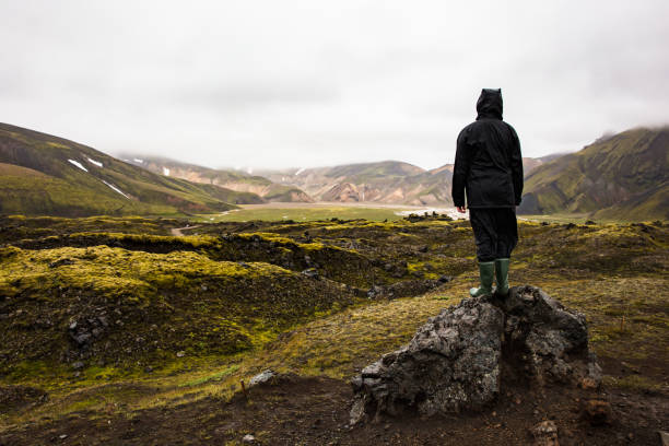 istock Female Hiker Standing On Rock While Enjoying Nature At Iceland 924985224