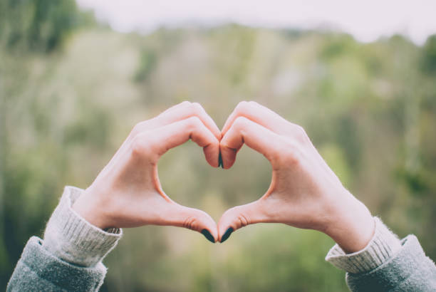 istock Tender girl's pale hands forming a heart shape gesture. 924988872