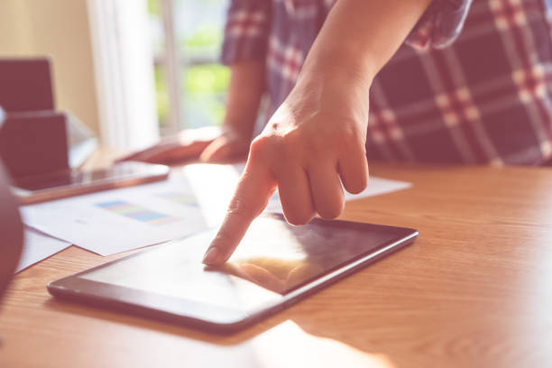 istock Finger touching tablet in business meeting desk 924991168