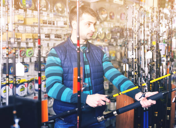 istock fishman choosing fishing rod 924994902