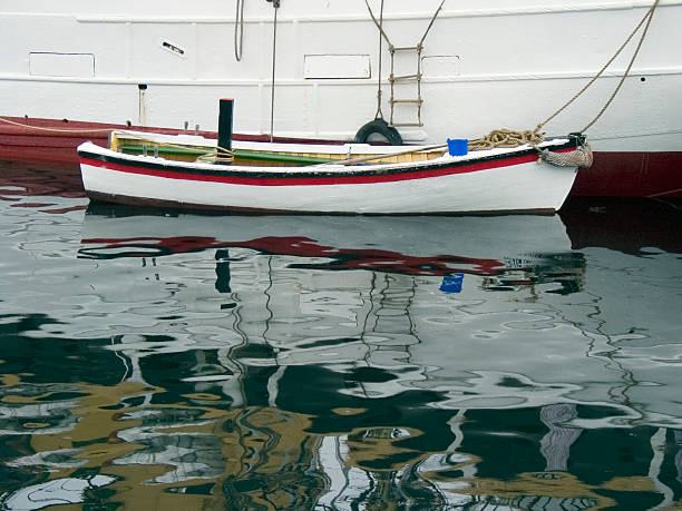 lifeboat reflected in water stock photo