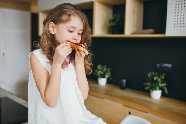 istock Little girl having breakfast 924996650