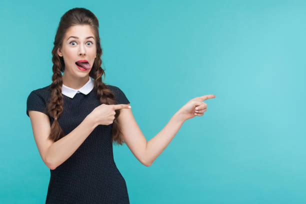 istock Crazy woman pointing finger at copy space. 925000706