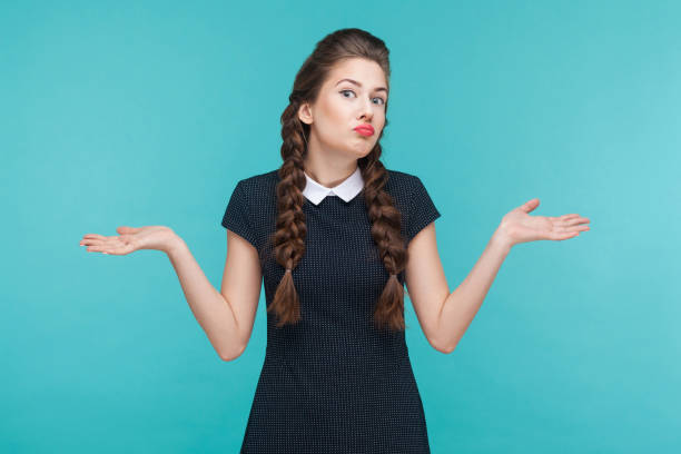 istock I don't know. Confused cute girl looking up 925000724