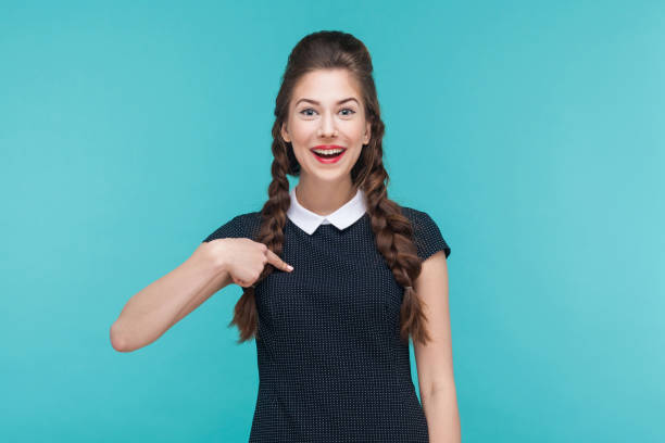 istock Expressive  woman pointing finger himself, toothy smile, looking at camera. 925000740