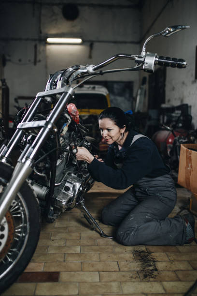istock Man worker in motorcycle repair shop 925004774