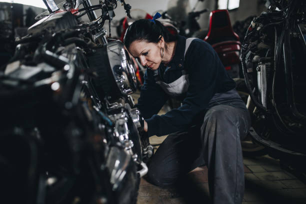 istock Man worker in motorcycle repair shop 925005032