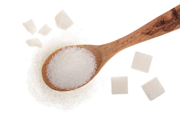 istock granulated sugar in wooden spoon with cube isolated on white background. Top view. Flat lay 925005954