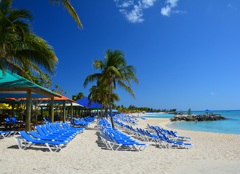 Blue sunbeds on beautiful beach. Eleuthera island, Bahamas
