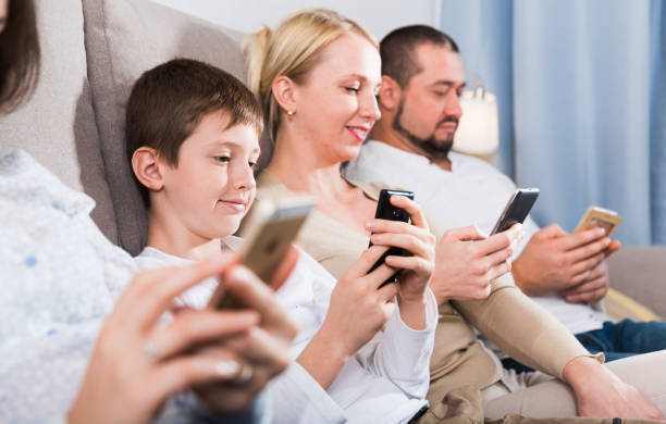 istock Parents with son using mobile gadgets at home 925017250