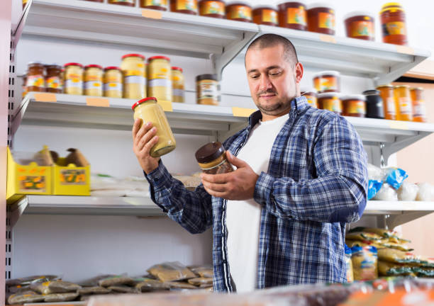 istock Happy male customer choosing pasta of nuts 925017302