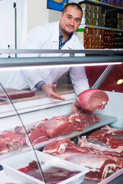 istock Butcher cutting fresh lamb meat 925017358