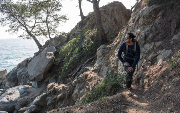 istock man walking among the rocks near a beach paradise 925021452