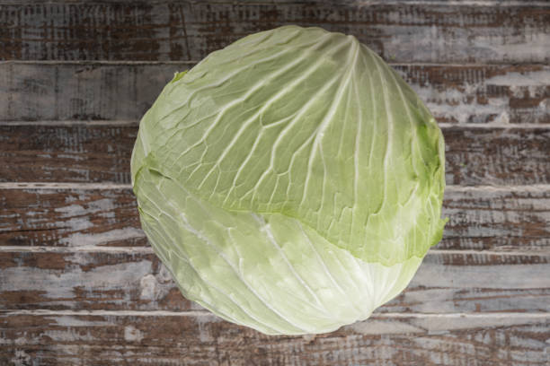 Fresh green cabbage on a wooden table
