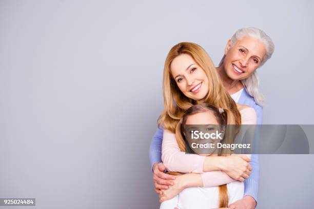 Portrait Of Charming Beautiful Friendly King Supportive Cute Family Members Hugging Each Other Isolated On Gray Background Copyspace Stock Photo - Download Image Now