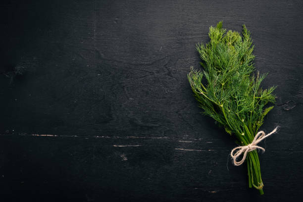 istock Fresh green dill on a wooden background. Top view. Free space for your text. 925025010