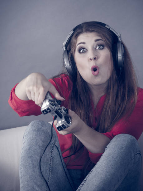 istock Young woman playing video games 925025326