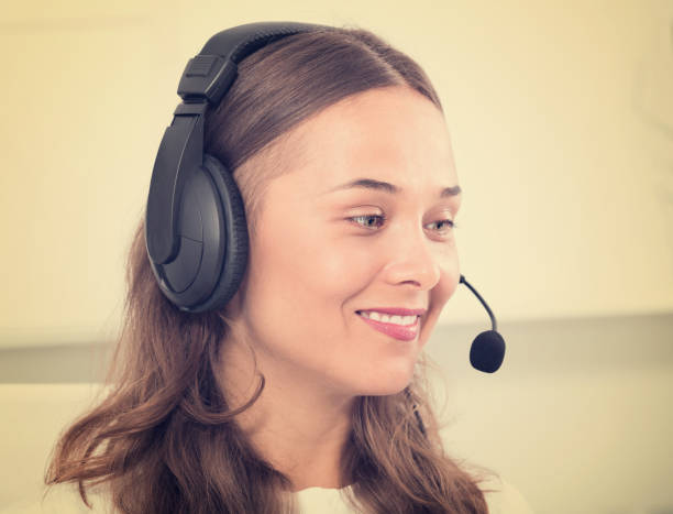 istock young woman with head set at office 925025626