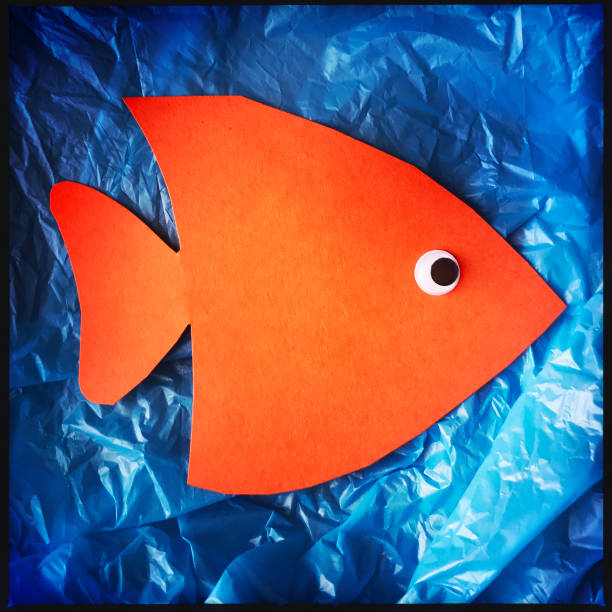 istock Paper Orange Fish on Plastic Grocery Bag Concept 925029296