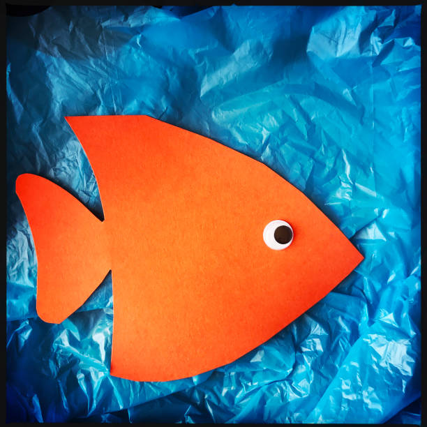 istock Paper Orange Fish on Plastic Grocery Bag Concept 925029300